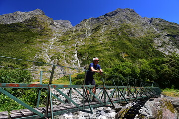 Tourist enjoying views of upper Clinton valley, Milford track, New Zealand