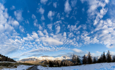 Panoramic view of fantastic sky with clouds on the snowy peaks of the Italian Alps