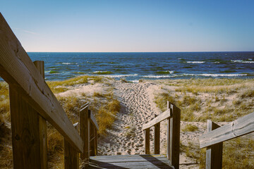 A Path to an American Lake, Lake Michigan, with footsteps in the sand past stairs.
