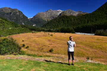 Naklejka premium Female tourist enjoying view of lower Routeburn Valley, New Zealand