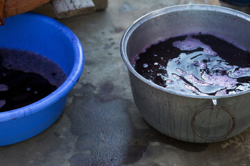 Grape juice close up during the autumn harvest. Traditional old technique of wine making. Filtering grape must.