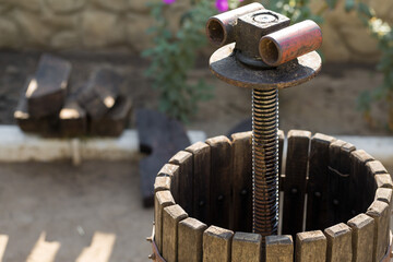 Winepress with red must and helical screw. Production of traditional Italian wines, crushing of grapes.
