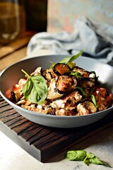 Baked eggplant with tomatoes, onion and feta cheese. Vegetable side dish. Mediterranean dish. Ratatouille french provence dish of vegetables. Healthy tasty food, vegetable ragout.  Hard shadows