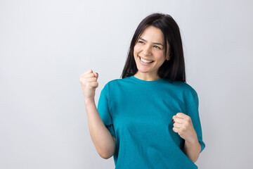 Close up portrait of attractive shouting in winning smiling with raised fists young she her girl wearing jeans shirt clothes isolated on grey background