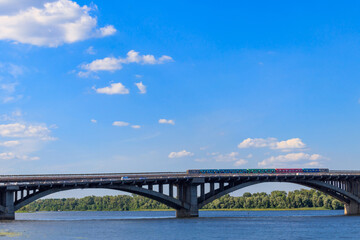 View of Metro bridge with subway train passing and the Dnieper river in Kiev, Ukraine