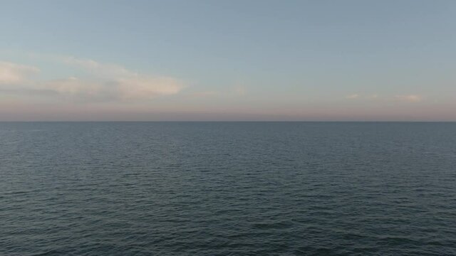 Flying at sunset over the Baltic Sea between Germany and Denmark. Ungraded Footage.