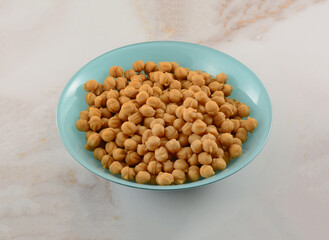 Small bits of caramel pieces for baking in blue ingredient bowl on table