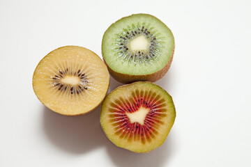 Kiwi Fruits in three different colors: Red Kiwi, Gold Kiwi and Green Kiwi isolated on white...
