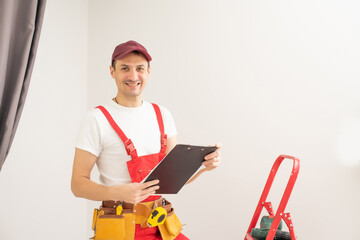 Smiling male architect with clipboard and pen against a white background.