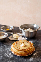 stack of pancakes and ingredients for making dough, Maslenitsa