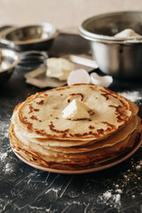 Baking products for making pancakes - Russian traditional cuisine: milk, eggs, flour, butter, на темном фоне