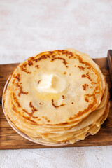 stack of pancakes with butter on white background