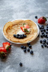 Pancakes with fresh berries. National Russian cuisine, the holiday of Maslenitsa.