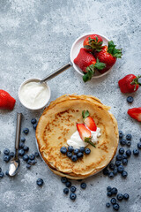 Pancakes with fresh berries. National Russian cuisine, the holiday of Maslenitsa.