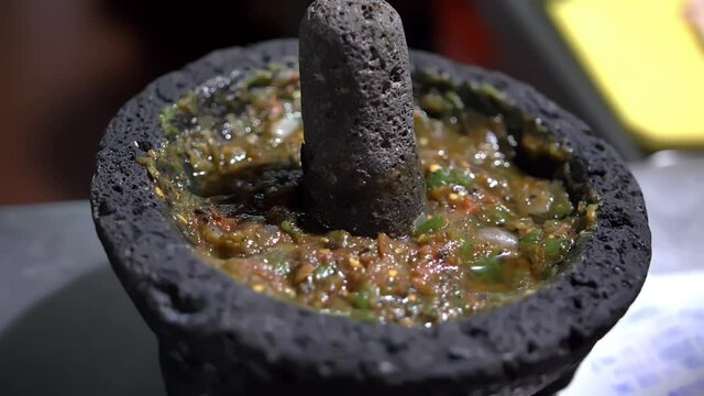 Close-up of traditional Mexican molcajete full of sauce