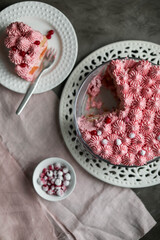 Delicate pink cake on a table with light dishes. Red currant tiramisu.