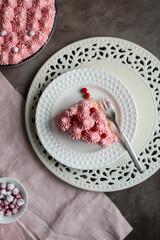 Delicate pink cake on a table with light dishes. Red currant tiramisu.