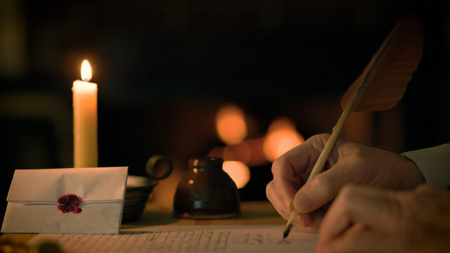vintage scene of a man writing with a quill pen in front of a fireplace