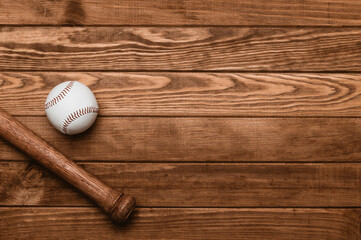 Baseball bat and ball on wooden floor.  Sport theme background with copy space for text and advertisment