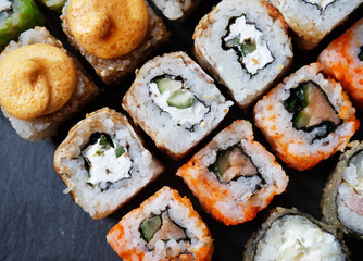 Mix of Japanese rolls in on a black background