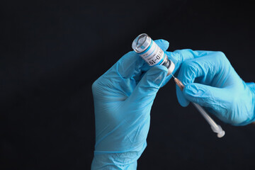 COVID 19 injection being filled from a vaccine bottle