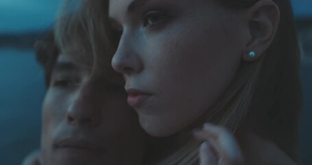 Attractive young caucasian couple hugging in front of the sea