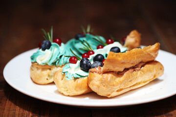 Juicy and bright eclairs with the taste of berries, caramel and strawberries