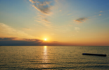 Amazing Sunset on the Sea. Adriatic sea, beautiful sunset, waves and landscape.  Lignano Sabbiadoro, Italy.