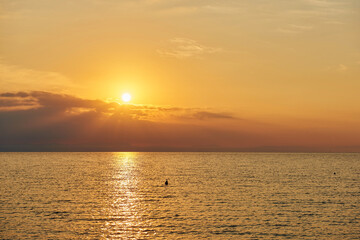 Amazing Sunset on the Sea. Adriatic sea, beautiful sunset, waves and landscape.  Lignano Sabbiadoro, Italy.