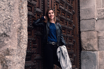 Woman smiling at the entrance of a building