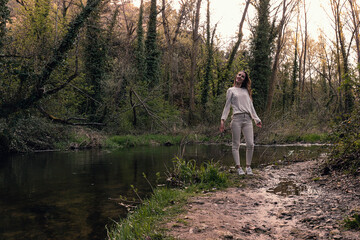 Woman stops on the bank of a river