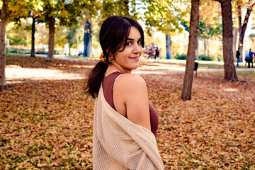 Smiling woman in a park in autumn