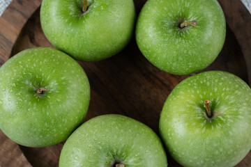Juicy apples isolated on a wooden platter