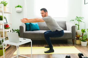 Side view of a good-looking man exercising at home