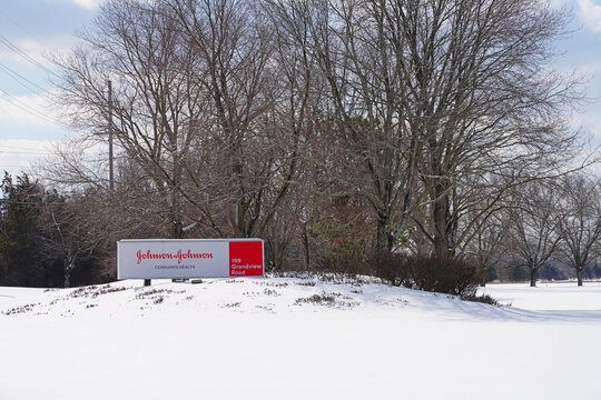 SKILLMAN, NJ -20 FEB 2021- View of a sign with the brand logo of Johnson and Johnson at the J&J Consumer Health division campus in Montgomery, New Jersey, United States, after a snowfall.