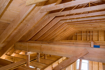 House attic under construction walls and ceiling material in wooden frame