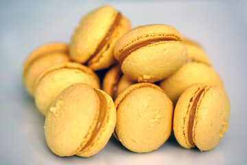 Yellow macaron cookies filled with lemon curd