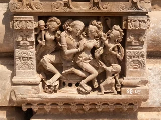 erotic stone carving of man with several women at harshat mata temple in the indian state of rajasthan © chris
