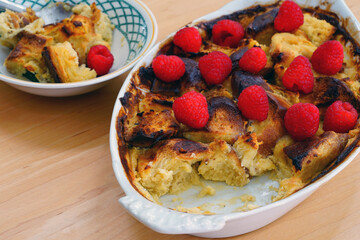 Dish of challah bread pudding with fresh raspberries