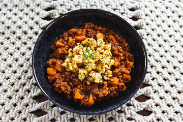 vegan pumpkin lentil and mushroom curry with truffle potato topping, healthy plant-based food