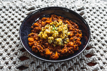 vegan pumpkin lentil and mushroom curry with truffle potato topping, healthy plant-based food