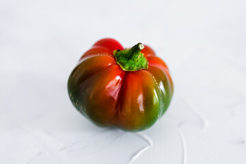 small bell pepper ripening from green to red isolated on white background, simple food ingredients