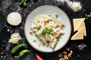 Pasta four cheeses. Italian food. On a wooden background. Top view. Free space for text.