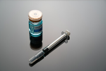 Medical concept ampoules or vials with Covid-19 vaccine on a laboratory bench 