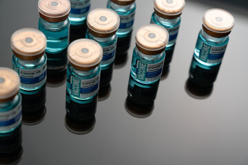 Medical concept ampoules or vials with Covid-19 vaccine on a laboratory bench 
