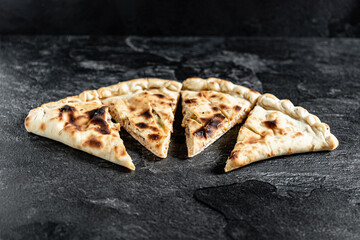 tasty italian calzone pizza with fresh ingredients and vegetables