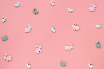 Festive Easter background of toy bunnies on pink. Texture.