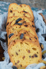 Classic sultana pie slices in a wooden basket on the blue towel