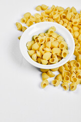 Top view of uncooked pasta on white background