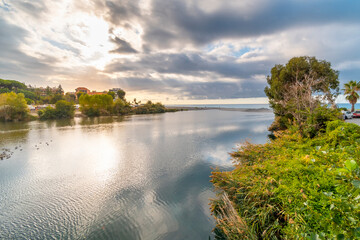 The Roya River leading to the Mediterranean Sea along the Ligurian Coast in the town of Ventimiglia, Italy.
